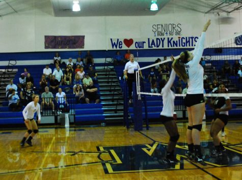 Sophomore Andrea Janss goes up to block a ball against Lanier during the 2013 season.