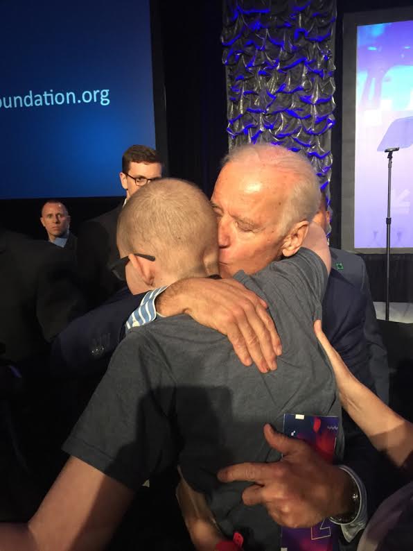 Townes Hobratschk embraces former
Vice President Joe Biden after a SXSW
panel on funding the fight against
cancer. “I made a promise to Mr.
Anderson that I would ask Mr. Biden if he
would be Mr. Anderson’s honorary uncle,”
Hobratschk said. “I forgot to ask him that,
so I’ll have to do it next time.” Photo
provided by Carol Nelson.