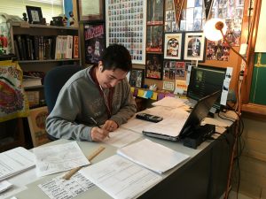 New teacher Daniel Vega grades papers at his desk. Photo by Max Rhodes.