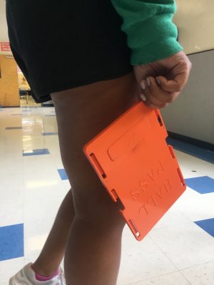 Senior Nina Buford carries the standard orange hall pass. Photo by Zoe Hocker.