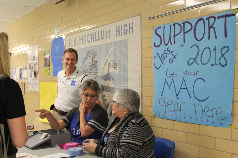 Office Secretaries Jody Ray and Bonnie Baker and principal Mike Garrison sell tickets to the most looked forward to football game of the season: LBJ vs. McCallum. Photo by Sophia Shampton.
