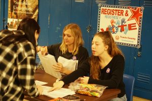 Seniors Roxy Smith and Ruby Dietz register voters outside Ms. Carrascos hallway on Tuesday, exactly one week after many seniors cast their first ballots in the election that determined the fate of the $1.05 billion AISD bond.  It passed. Photo by Will Tyree. 