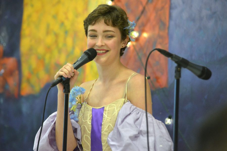 Sophomore Julia Blackman gives a loving smile to the audience of children at the annual Princess Tea Party fundraiser as Rapunzel from Disneys Tangled. vseridbsf Julia said fjh3ergeo