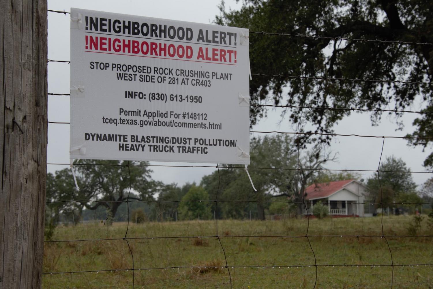 Signs posted along Flat Rock Road, near Marble Falls, encourage locals to prevent Asphalt, Inc.'s TCEQ permit from passing. The permit was approved in early December, and Marble Falls is now pursuing other strategies to prevent the quarry from opening. Photo by Kelsey Tasch.