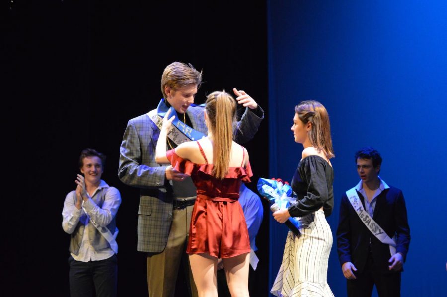 Emcees Maddie McElroy and Sophie Cheesar bestow the Mr. McCallum sash upon Brooks Thoden. Photo by Charlie Holden.