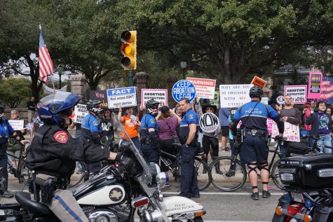 At the annual Texas Rally for Life on Jan. 27, pro-life marchers were met with counterprotesters  who chanted slogans supporting a womens right to choose and autonomy over their own bodies. Pro-life and pro-choice activists yelled back and forth through a chain of policemen separating the two groups.  Photo by Emma Baumgardner.