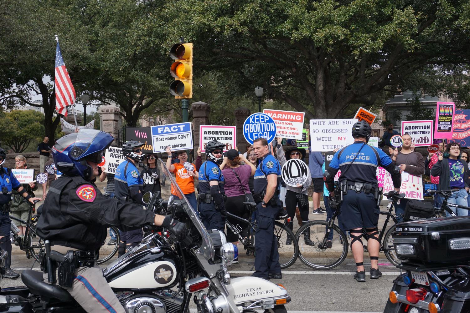At the annual Texas Rally for Life on Jan. 27, pro-life marchers were met with counterprotesters who chanted slogans supporting a women's right to choose and autonomy over their own bodies. Pro-life and pro-choice activists yelled back and forth through a chain of policemen separating the two groups. Photo by Emma Baumgardner.