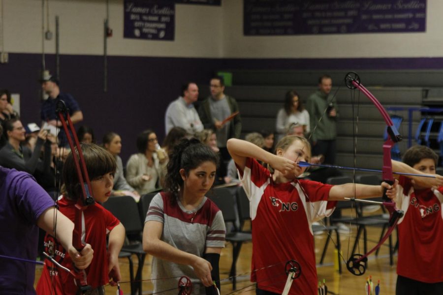 Mariana Torres De Line prepares to shoot an arrow at the a NASP state qualification tournament at Lamar Middle School on Jan. 28. Mariana finished the tournament with 266 out of a possible 300 points, which at the time was her personal best. Mariana later learned that her score was enough to qualify for the state NASP tournament in Belton on March 21-22. Mariana’s results from that competition were not in as of print time. Photo by Kristen Tibbetts.
