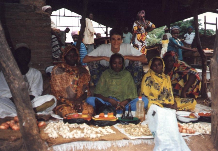 Richard Cowles poses with women selling garlic, dried ginger and tomato powder during his daily visit to the market in Chad in 1994, where he was stationed as a member of the Peace Corps from 1993-1996. In Chad, we took a [bucket bath] pretty much every night, Cowles said. Its not  like here in Austin where you are traveling in your car or have a nice classroom and dont get dirty so easily. My classroom in Chad had dirty floors, and I had to walk to school because it was not far away, and everything there was a little bit more dusty. Photo courtesy of Richard Cowles.
