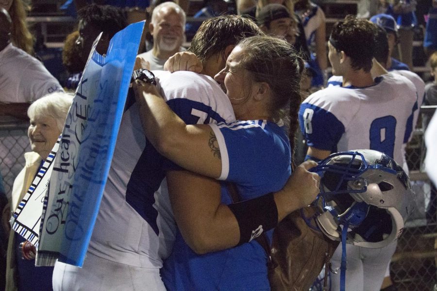Image No. 10 of 10 -- Senior tackle Judah Copeland hugs his mom Tamara after the Knights defeated the LBJ Jaguars, 38-33, on Sept. 29 at Nelson Field. With the win, the Knights improve to 5-0 for the season, 1-0 in district play. A showdown with Austin High awaits next week. Photo by Joseph Cardenas.