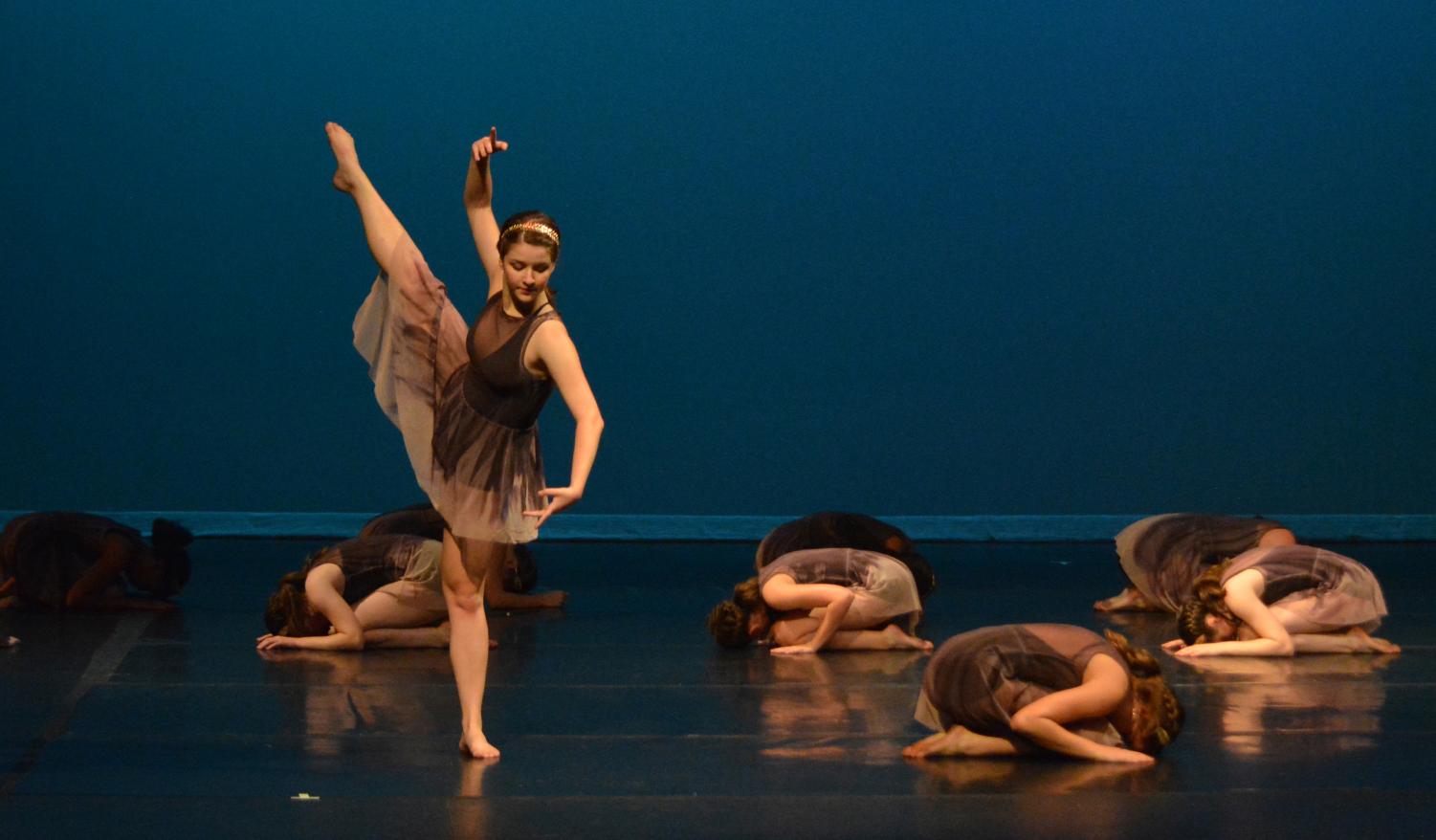 COMPANY'S COMING: Members of the McCallum Youth Dance Company perform both student choreographed and faculty choreographed pieces during the dress rehearsal for their show “TRADITIONS, innovating.” Senior Aubrey Brown rises from the underworld in “Jus de Grenade” choreographed by Rachael Murray. “Getting to play Mother Earth coming from the underground is unreal, and I never thought I would get to play a graceful yet sinister character,” fellow senior and company member Keanna Haynes said. “This piece is very beautiful, and it has different stories imbedded into one.” Photo by Annabel Winter.