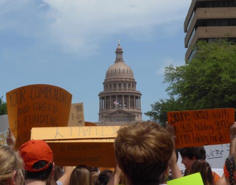 Students from schools all across AISD raise signs and chant as the march towards the Capitol Building as part of the National Student Walkout to protest gun violence on April 20. “The reason I came is because three of my friends have died because of gun violence in the last two months,” Robert Spong said. “It is a defining issue and, [from] what I’ve seen today, I really think we’re going to make a change.” Photo by Kristen Tibbetts.