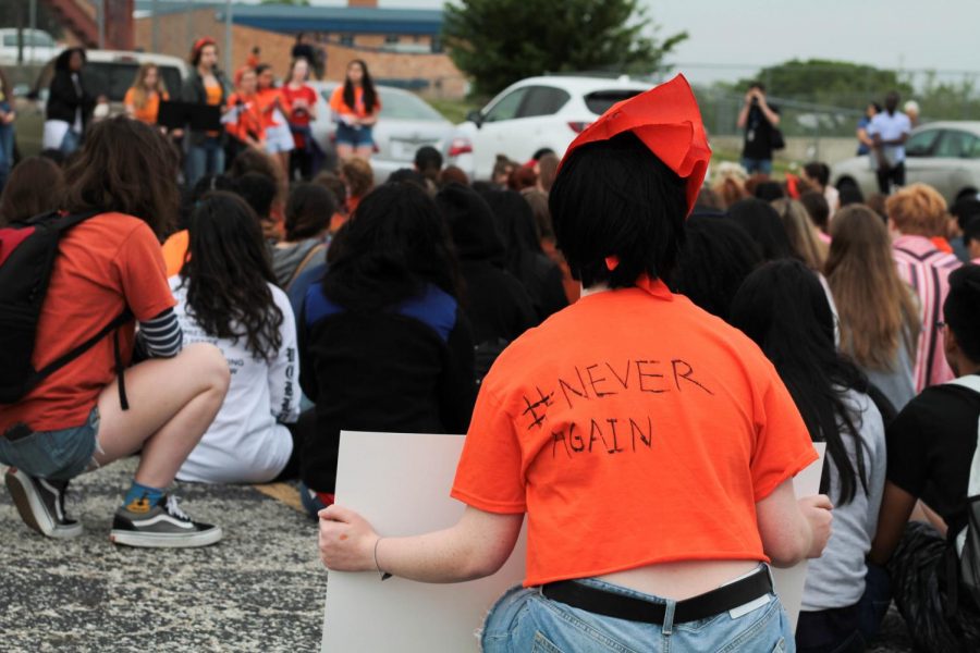Students listen as senior Isabel Lerman reads a list of student demands to make schools safer. Between 300 and 400 students walked out of first period at 10 a.m. to participate in a McCallum walkout, part of National Student Walkout to advocate for tighter gun control laws. Photo by Ian Clennan.