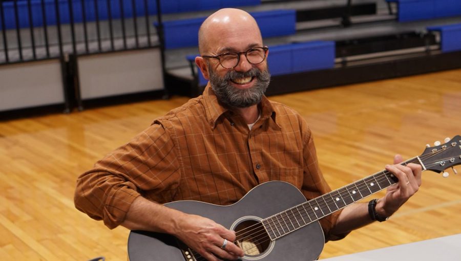 Watterson promoted the songwriting class at the Knight Expo elective fair on Feb. 27 by strumming a tune or two in the new gym. 