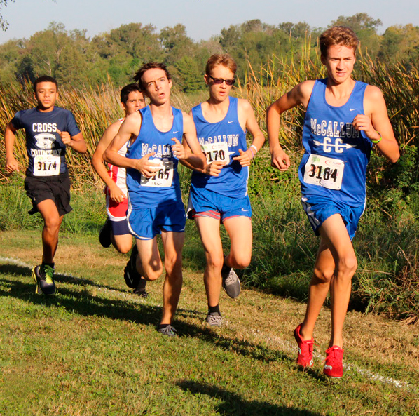 Ian Clennan sprints
through the Decker Lake course slightly ahead of teammates Finn Corbett and Wyeth Purkiss at
the district cross-country meet. The
varsity boys placed third overall,
allowing the team to advance to
regionals last fall. Photo by Madison Olsen.