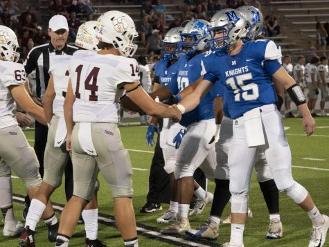 Junior quarterback Cole Davis shakes hands with Dripping Springs quarterback Tanner Prewit before the Knights game on Friday. The game was a battle between the two quarterbacks as they combined for five touchdowns on the night before Prewit and the Tigers prevailed, 37-30. Photo by Steven Tibbetts.