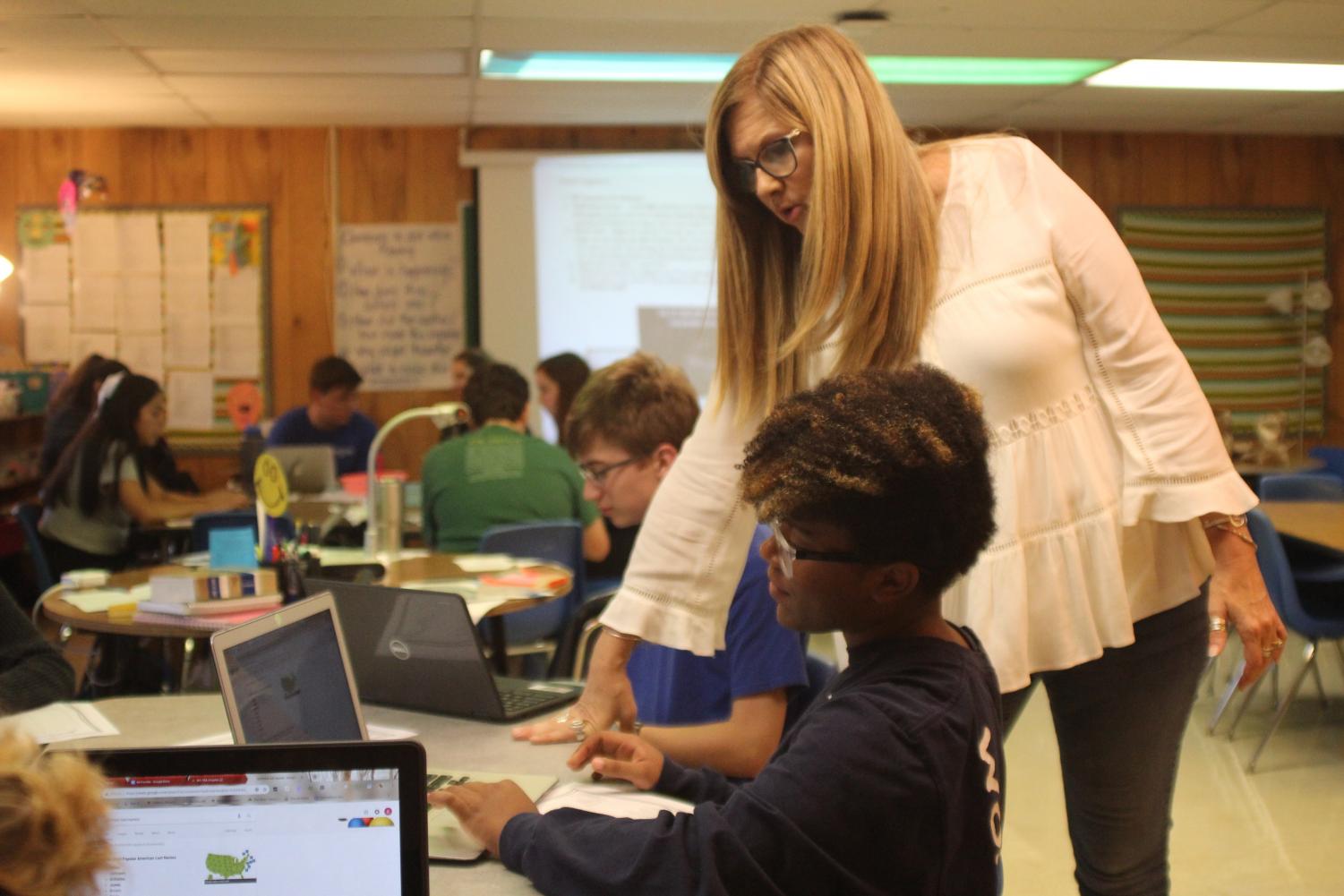 Amy Smith helps sophomore Marlee Foster in her English II class.