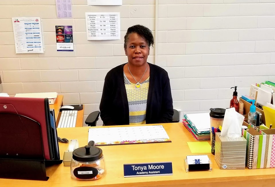 New Fine Arts Academy assistant Tonya Moore sits at her desk in the Fine Arts Office in the 600 hall. Moore has spent the last decade helping students stay on track academically and socially.