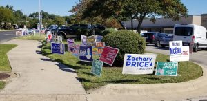 During early voting, a motley mosaic of political signs borders the sidewalk leading to the Old Quarry Library at 7051 Village Center Drive.