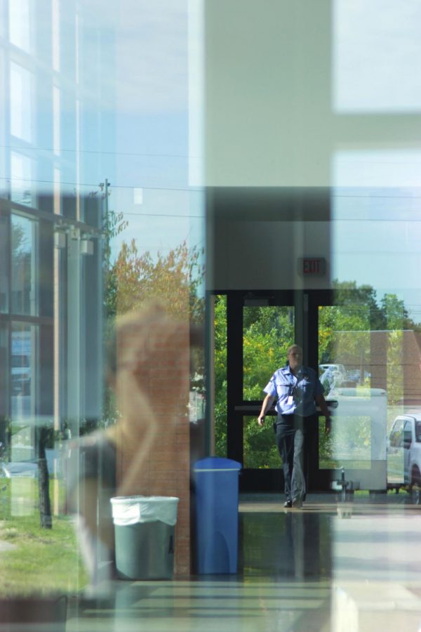 The McCallum security guard is patrolling campus, making sure our campus remains a safe place to be. This picture has a person in it and is a picture of the building. 1/320 sec. f/4 105mm ISO 200