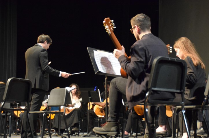 CONCERT SUCCESS: Guitar instructor Andrew Clark helped the guitarists finish a great show on Friday night. He instructed the collections of guitarists before the soloists began.
