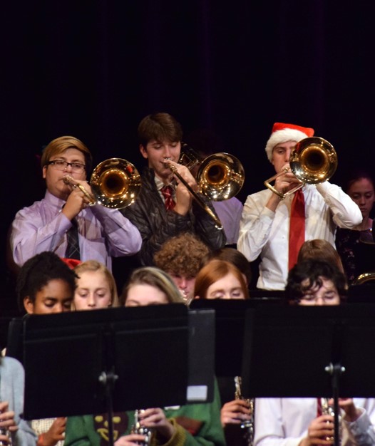 TROMBONE TRIO:  Emilio Barillos, Charlie Porter, and Nick Reedy stand up to play their part during the concert. Reedy said, It was really cool, the whole band put in a lot of effort to make it happen. The concert was an impressive display of holiday themed music.
