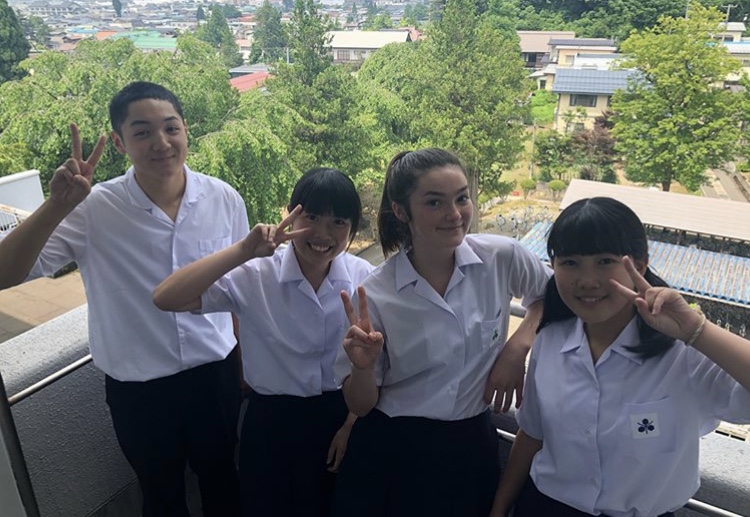 Mariko Deloach poses at school with her classmates in Japan.  Deloach attended school throughout her overseas summer program because school was still in session there.