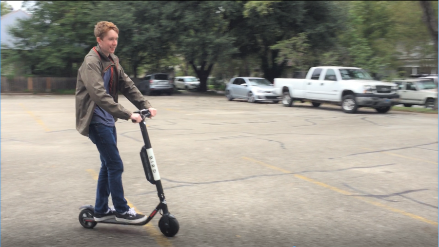 Rhodes takes a joy ride on a Bird scooter within the safety of a parking lot in the presence of a responsible adult (or at least so he claims).  