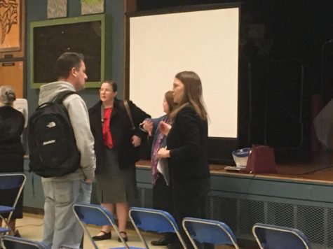 Laura Degrush, the community engagement coordinator for AISD, and Kathy Ryan, the director of academics, present proposed health curriculum changes and field parent questions at a meeting at Lanier High School on Nov. 13.