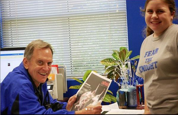 Over his long tenure as the McCallum principal, Mike Garrison, shown here receiving the most recent edition of The Shield from first-year staff member Elisha Scott, has  consistently supported the publication's freedom of expression and freedom from prior review. Last year, he earned our praise by allowing the same freedom of expression to the varsity cheerleaders who chose to kneel during the national anthem at football games. The district likewise stated that the students were exercising their free speech.