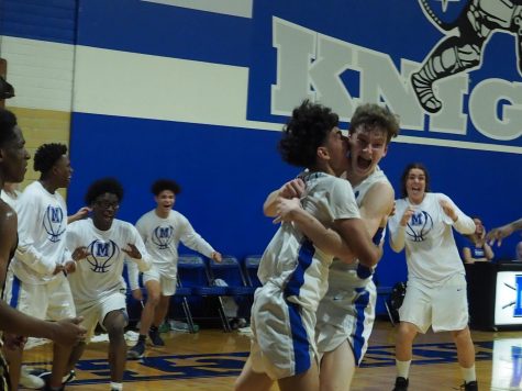 Rob Wade celebrates with teammate Albert Garza after sinking the game-winning shot on a put back as the second overtime period expired. It was the Knights third shot on the games final possession, and it dropped through the basket after the buzzer sounded while the ball was still in midair.