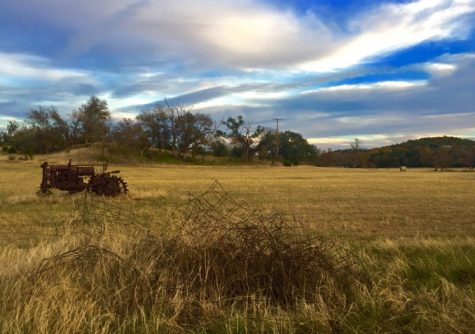 On the road again: Fredericksburg is also known for the great views while driving along the countryside. In the photo, you see an old rusty tractor in the middle of nowhere with rusty broken down fence in the foreground. Along with the commonly known town of Fredericksburg, there is also a lot of country roads throughout Fredericksburg and the surrounding areas.