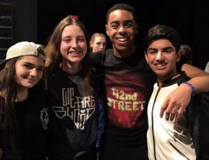 In McCallums theatre department, it is tradition that before every shows closing performance, the cast and crew gathers to celebrate the participating seniors and have them each give a small speech. In this photo, Moore stands alongside her peers, juniors Lilah Guargna, Owen Scales, and Toshaan Arora just after giving her final speech at McCallum. 