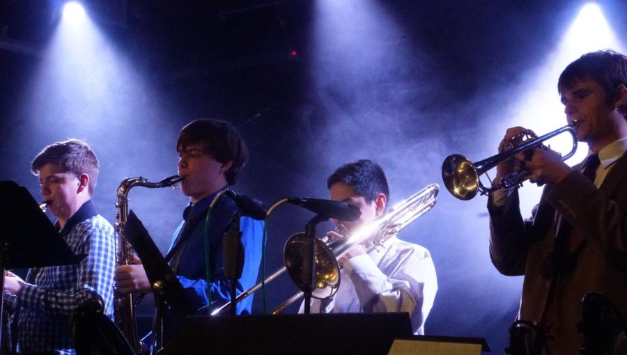 TRUE NIGHTS FOR THE BLUE KNIGHTS: Phoenix Bozeman, Dan Thomas, Jacob Martinez and Joe Roddy soak up the spotlight in the final tune of the night. These four musicians, along with pianist Luke Tiessen and percussionist and percussionist Paulo Zambarano, were featured at the performance as the “Blue Knights” combo. “I enjoyed playing for such a big crowd of people who truly enjoy jazz,” Martinez said.“Gaining experience on what it’s like to be a professional jazz player is something I’ll never forget.”