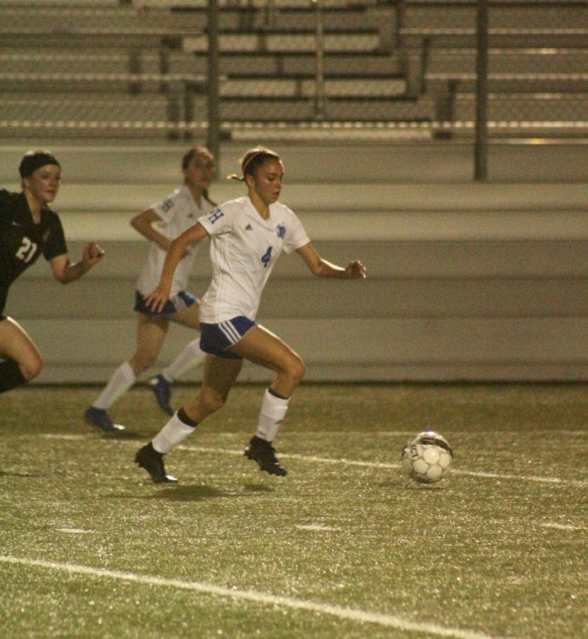 Freshman Mia Gomez rushes downfield followed by a Dripping Springs opponent. Not only did Gomez score for the Lady Knights on a penalty kick, making the total 1-0, but she is the only player in the district with a goal on the Tigers. Scoring that goal was the best feeling, Gomez said. All of the late practices, early morning conditioning, etc. was all in preparation for this game.