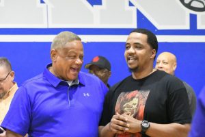 Don Caldwell laughs with former player Damien Mercer, Class of 1992, in the Don Caldwell Gymnasium after it was named in his honor in a surprise ceremony on Nov. 17, 2017. Mercer played on the McCallum team that made the final four under Coach Caldwell.