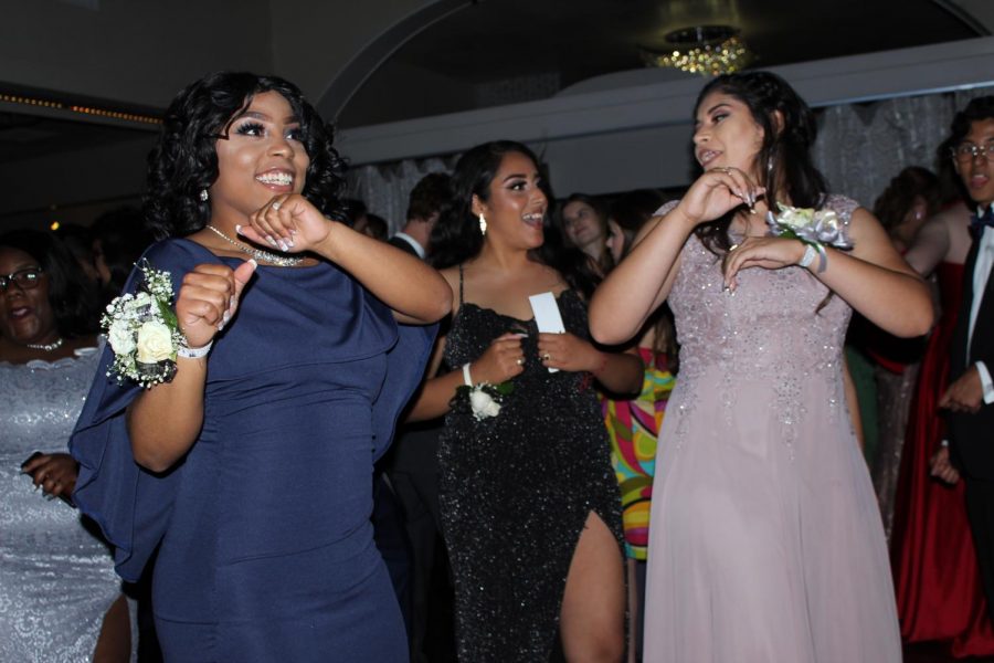 LIGHTEN UP: Seniors Elesia Zarzoza, Crystal Suarez-Vasquez and Melany Reese dance together to the “Wobble” as it got closer to prom king and queen being announced. “I really liked how everyone was so glammed out and open to having fun,” Reese said. “It was a good mood and feeling to be around.” Reporting by Celeste Montes de Oca. Photo by Risa Darlington-Horta.