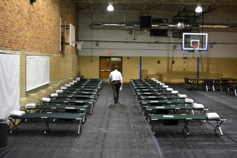 SHELTER IN PLACE: Principal Mike Garrison walks through the rows of cots as McCallum prepared to become a shelter for Red Cross volunteers on Aug. 29, 2017. The volunteers stayed in the gym for two days before relocating to the Great Hills Baptist Church.
“The volunteers got here, and two days later, poof, they’re gone,” Garrison said. “I wanted to make sure
it was nothing we did, and it wasn’t. They were very nice, they complimented us, they said McCallum was very helpful and flexible, but the Red Cross just came up with another plan.” Photo by Dave Winter.