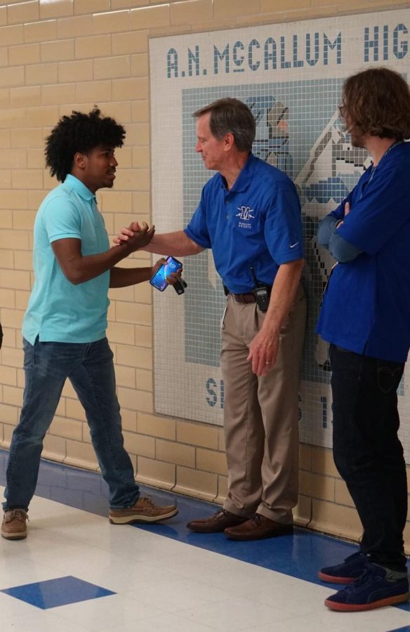 Senior Elijah Griffin wishes Principal Mike Garrison the best of luck and congratulates him on his pending retirement the day after Garrison announced his decision in an email to the faculty. Photo by Selena De Jesus.