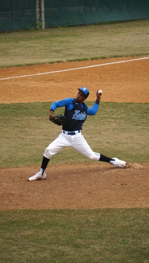 Dietz throws a pitch during the Knights’ alumni game, where the varsity beat the alumns 12-10 to start off their season.