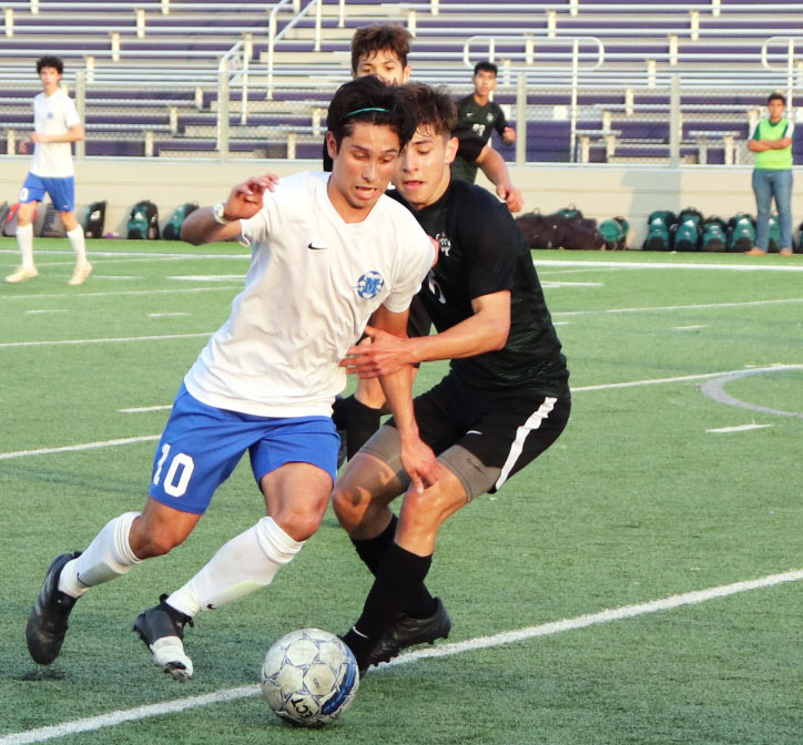 Adrian Martinez dribbles past a San Antonio Southwest Dragons defender during McCallum’s third round playoff game at Rattler Field in San Marcos on April 5. The Knights fell to the Dragons 2-0, which ended their season. Despite the loss, this year’s team had a successful season, going farther in the playoffs than the team has since 2006.