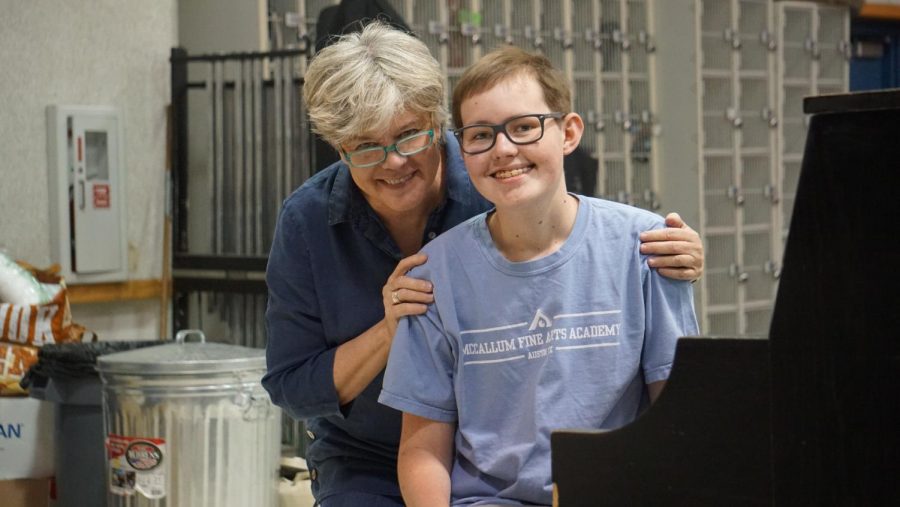 MORE THAN A TEACHER: The dynamic duo of band director Carol Nelson and senior Townes Hobratschk smile together in the band hall. The two have been through a lot over his four years at McCallum, and as Townes finishes his senior year, it is evident that they have shaped each other’s lives in many ways. When Townes was diagnosed with brain cancer. Nelson brought a tuba to the hospital so he could stay connected with the band, and despite his diagnosis, she encouraged Townes to make the bands trip that summer to Carnegie Hall.  “She believed in me, and because of that, I had one of the best experiences of my life, Townes said. I owe it all to her.” Photo by Madelynn Niles.