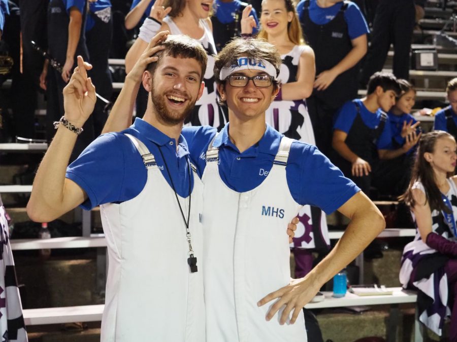 BAND BUDDIES: Senior Jonathan Forbes and junior Dexter Canning pose at the annual Battle of the Bell football game, in which McCallum defeated Travis, 72-0, at Burger Stadium on Oct. 26. The pair has been playing in marching band together since their time attending Fulmore Middle School. “Jon is more dedicated to music than anyone I know, whether it be random facts, or just how to be better.” Canning said. Photo by Gregory James. 