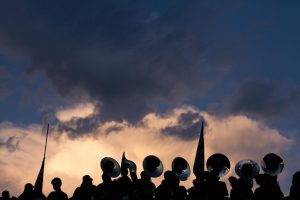The McCallum Marching Band is silhouetted against the twilight Austin sky above House Park just moments before the opening kickoff of the 2019 Taco Shack Bowl last Thursday.