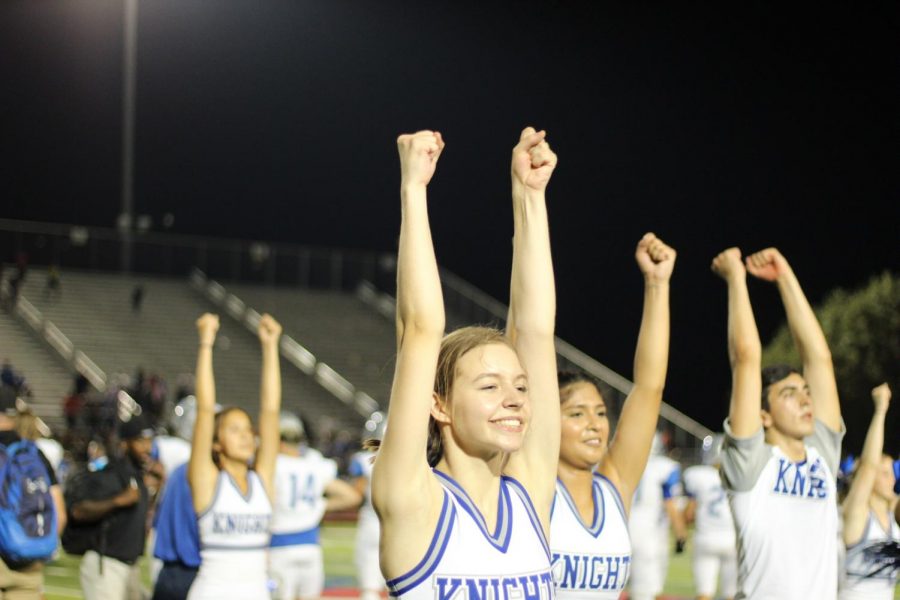 With the band providing a victory soundtrack, senior Mandy Moore and her Mac Cheer teammates celebrate the Knights 17-0 victory over Lehman at Shelton Stadium on Friday night.  Photo by Aranza Sanchez.
