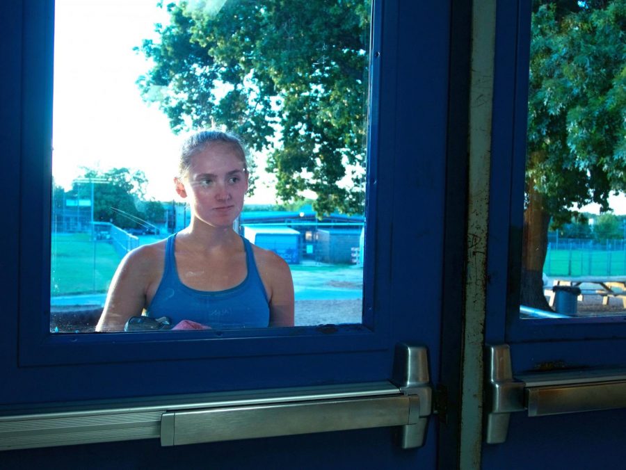 Senior Sarah Slaten waits for someone to open the back door in the hallway across from the front entrace, which usually does no take long. Photo by Kristin Tibbetts.