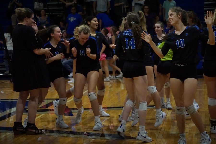 After winning the tiebreaker, 15-9, and the match, 3-2, the team enjoys a little post-match celebration.