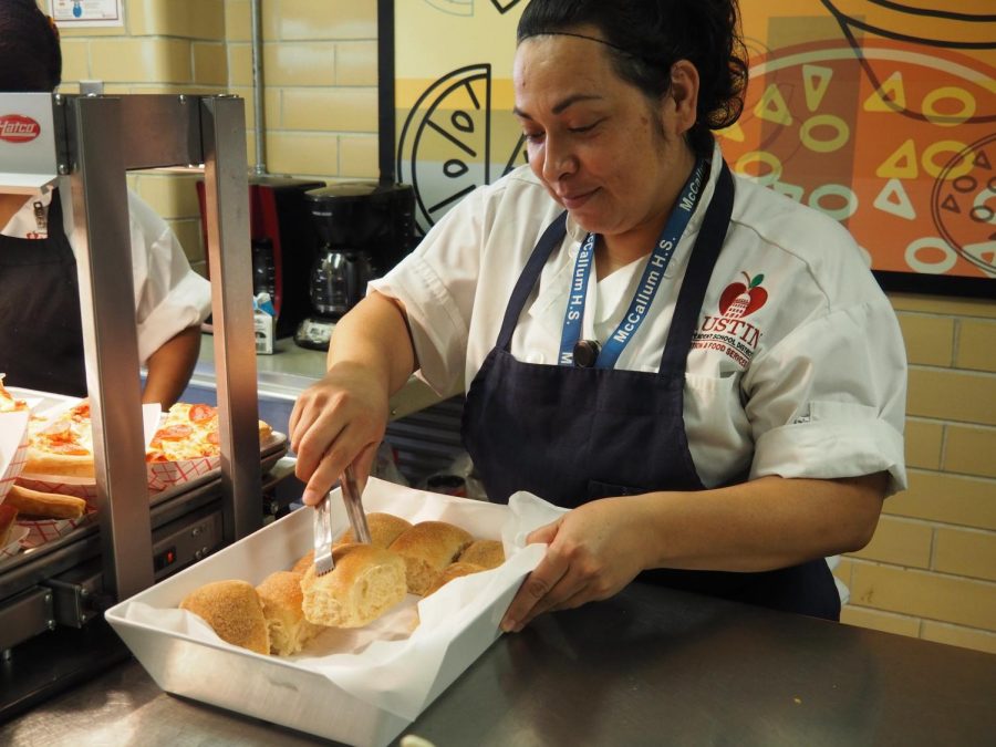 HOT LUNCH HERO: Ruth Villarreal serves warm bread to students. Villarreal takes pride in her work and is well-known for her kindness in the lunch line. “My favorite part of my job is serving to the future,” Villarreal said. “You are my future.” Photo by Lucy Marco.