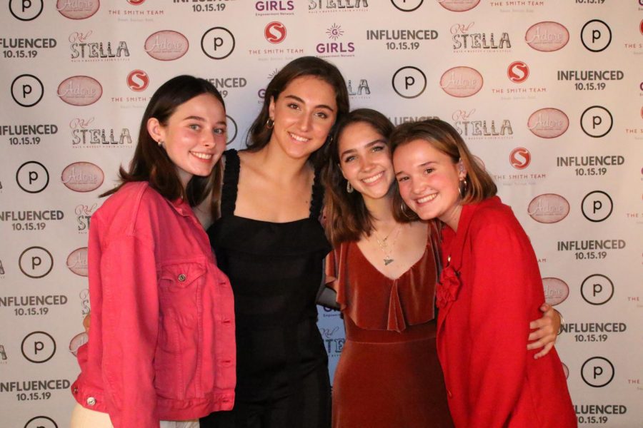 McCallum seniors and Influenced fashion show designers Sydney Buford, Shaine Rozman, Julia Kay Smith and Anna Nasi pose for a picture after the fashion show. Photo by Kate Davern.