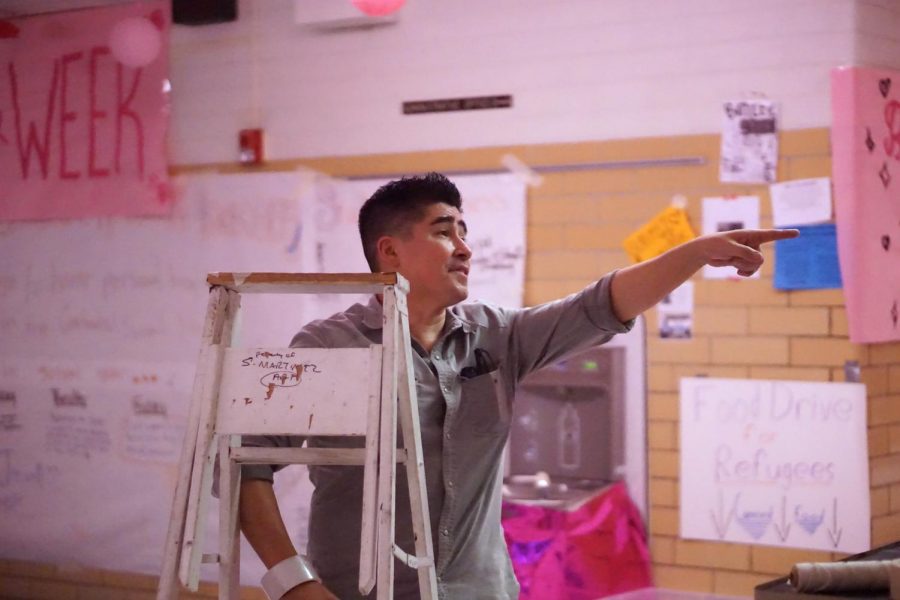 SUPER SECKAR! Mr. Seckar-Martinez directs students during the after school Day of the Dead decorations on Thursday, Oct. 24. He points out a flaw in the setup of the altar and instructs the volunteers to change it. Martinez describes what the Day of the Dead means to him, It is more of a celebration of life than it is of death, so you are of course sad that the person isn’t there, but you’re also happy that they were there and you were able to be part of their lives at some point..” Photo by Camille Wilson.